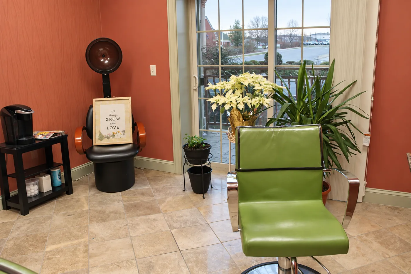 Bright styling station with a green chair at Nu Look Salon