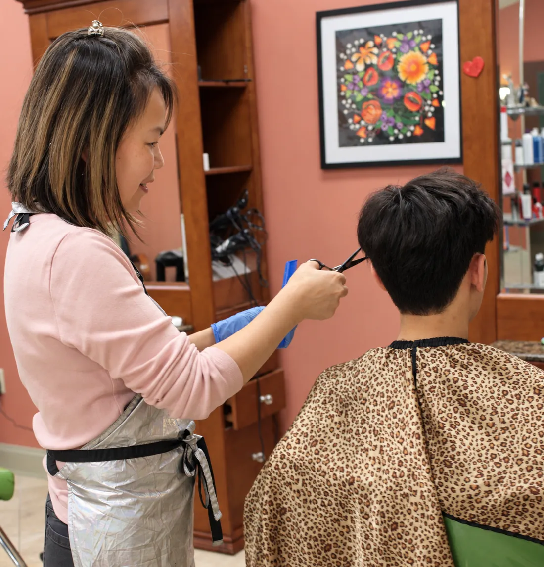 Vicky cutting a client's hair at Nu Look Salon